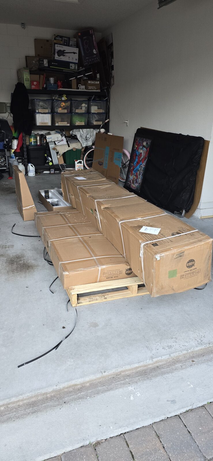 Pro Dunk Thor Silver basketball hoop boxes stacked on a pallet in a garage on delivery day