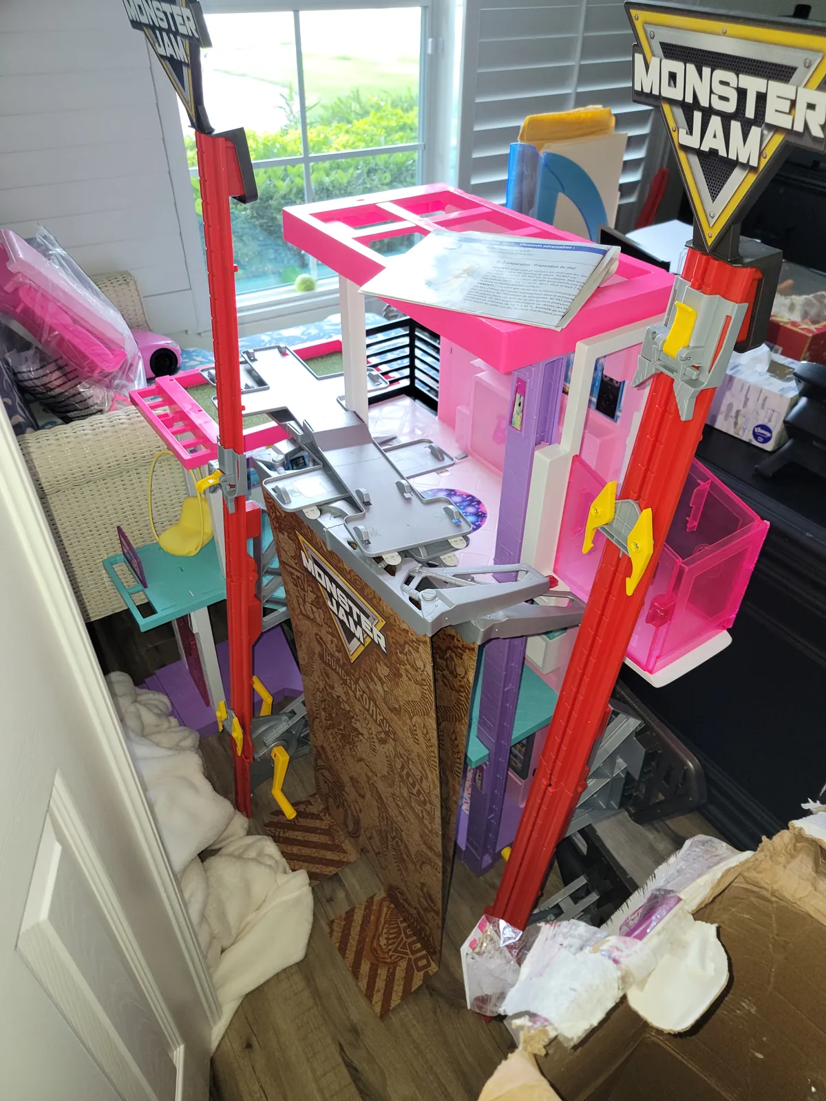 Barbie Dreamhouse and Monster Jam playsets assembled and staged for Christmas morning in a Florida home