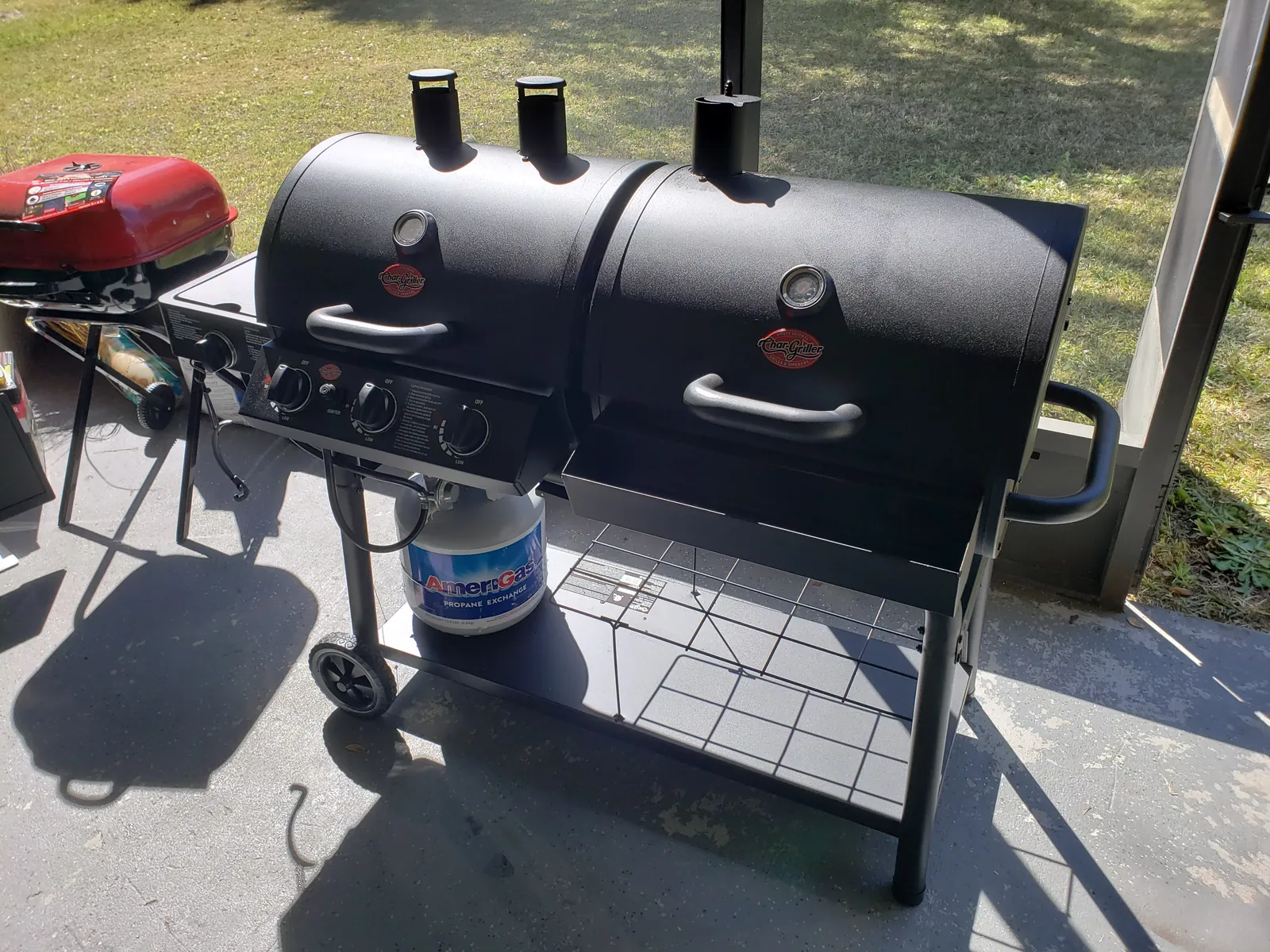Char-Griller gas grill and offset charcoal smoker combo assembled with propane tank hooked up in Florida