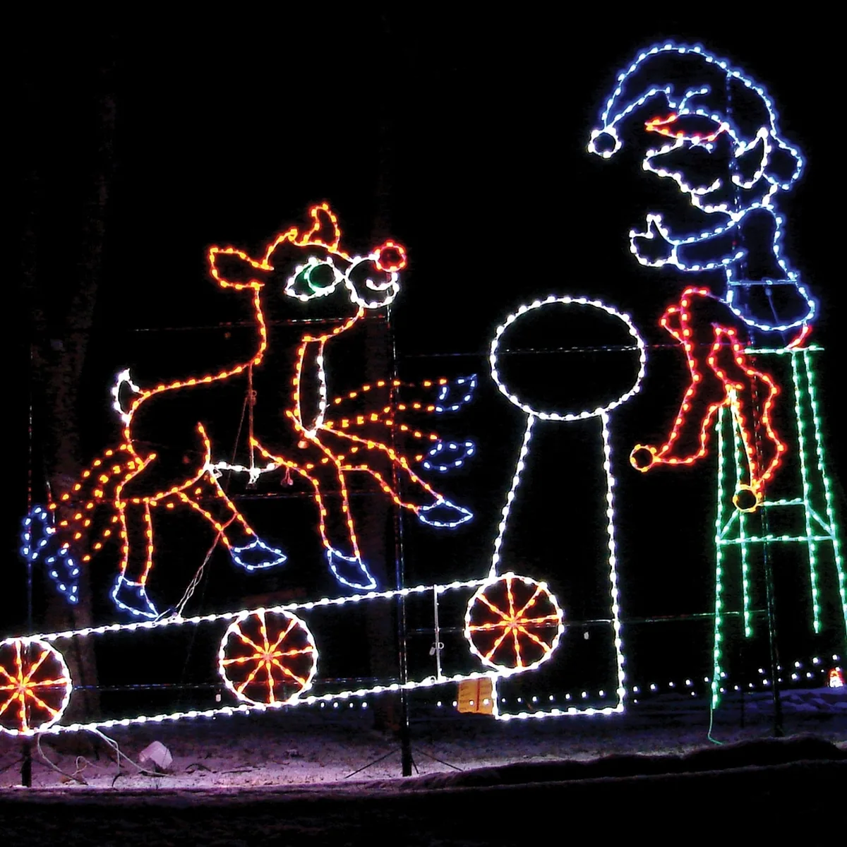 Rudolph the red-nosed reindeer LED light display assembled and glowing in a Florida front yard on Christmas Eve