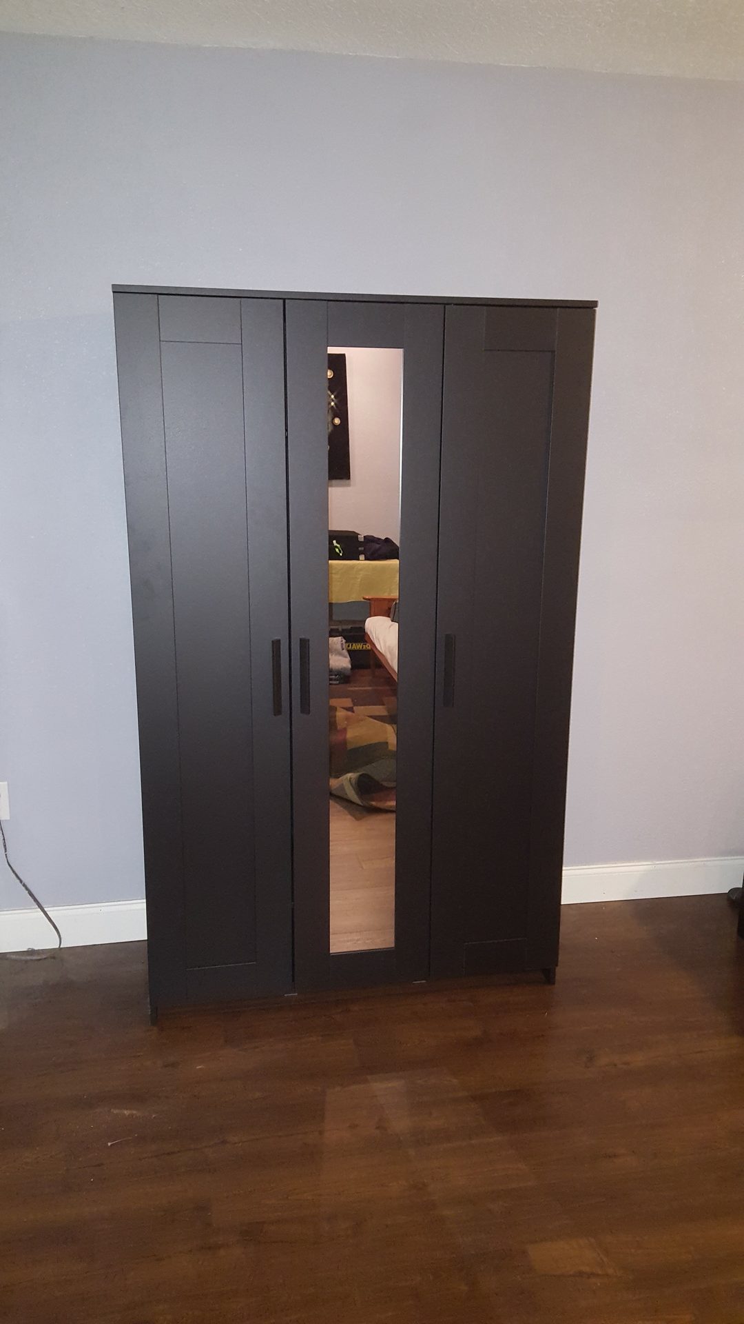 Dark IKEA three-door wardrobe with center mirror assembled freestanding by DR Assembly