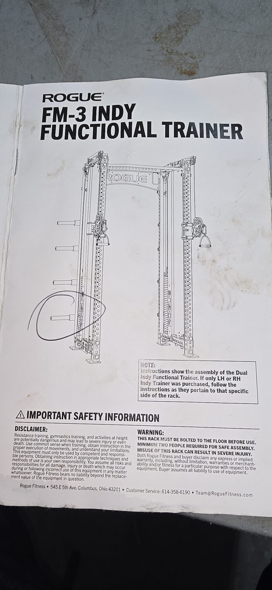 Rogue FM-3 Indy Functional Trainer assembly manual cover page showing dual-stack cage diagram and safety warnings