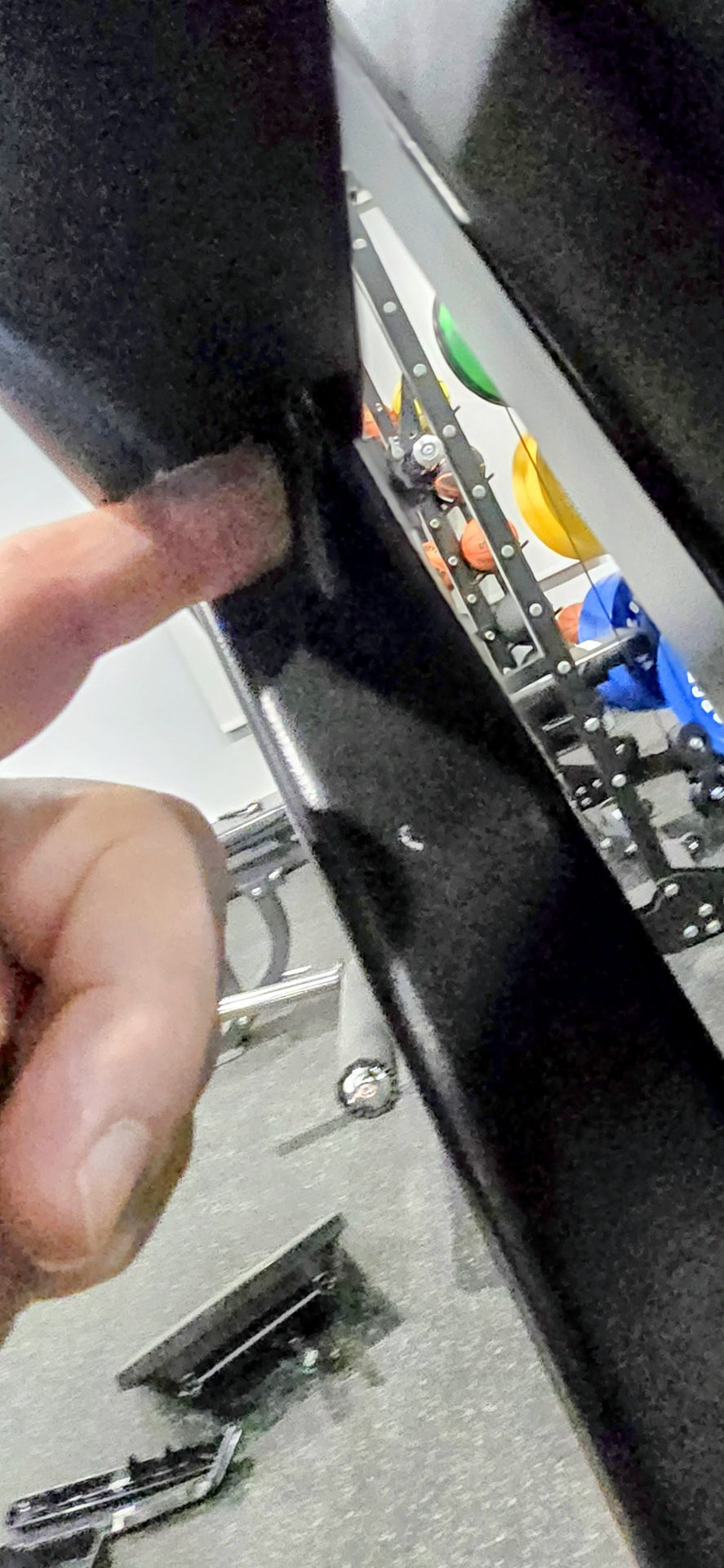 DR Assembly technician torquing treadmill uprights without damaging the wire harness